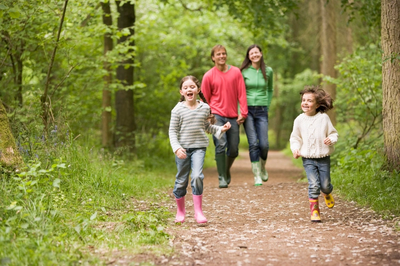 Family Walking Through Forest